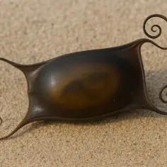Skrzek rekina na piasku, z charakterystycznymi spiralnymi wąsami.